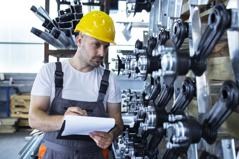 Engineer inspecting production on a factory floor